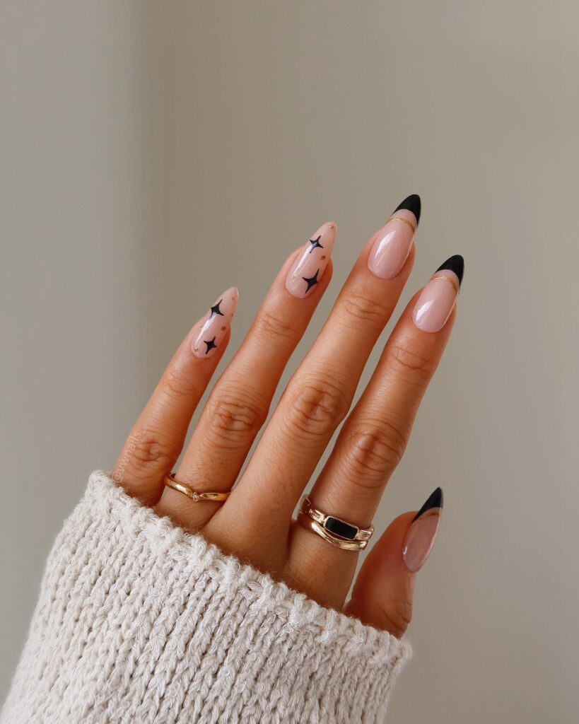 black and gold star French tip nails