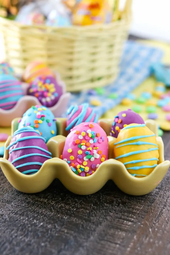 easter egg shaped cookie dough balls coated in colorful chocolate and sprinkles