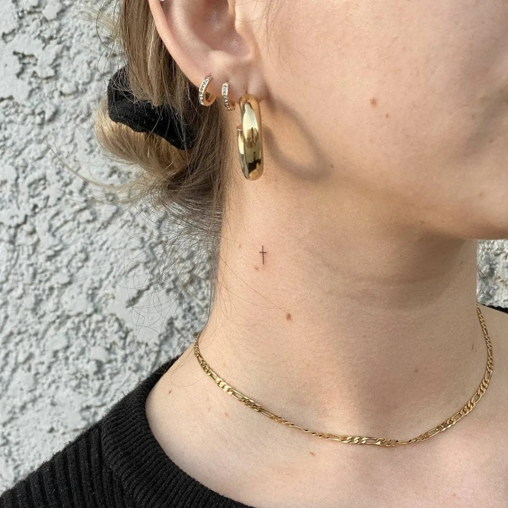 mini cross neck tattoo