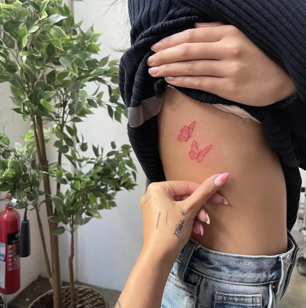 red butterflies ribcage tattoo