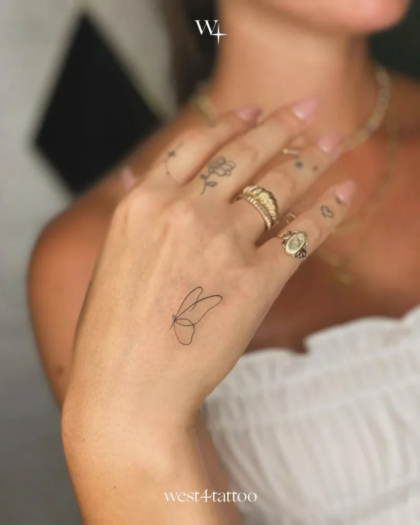 single line butterfly hand tattoo