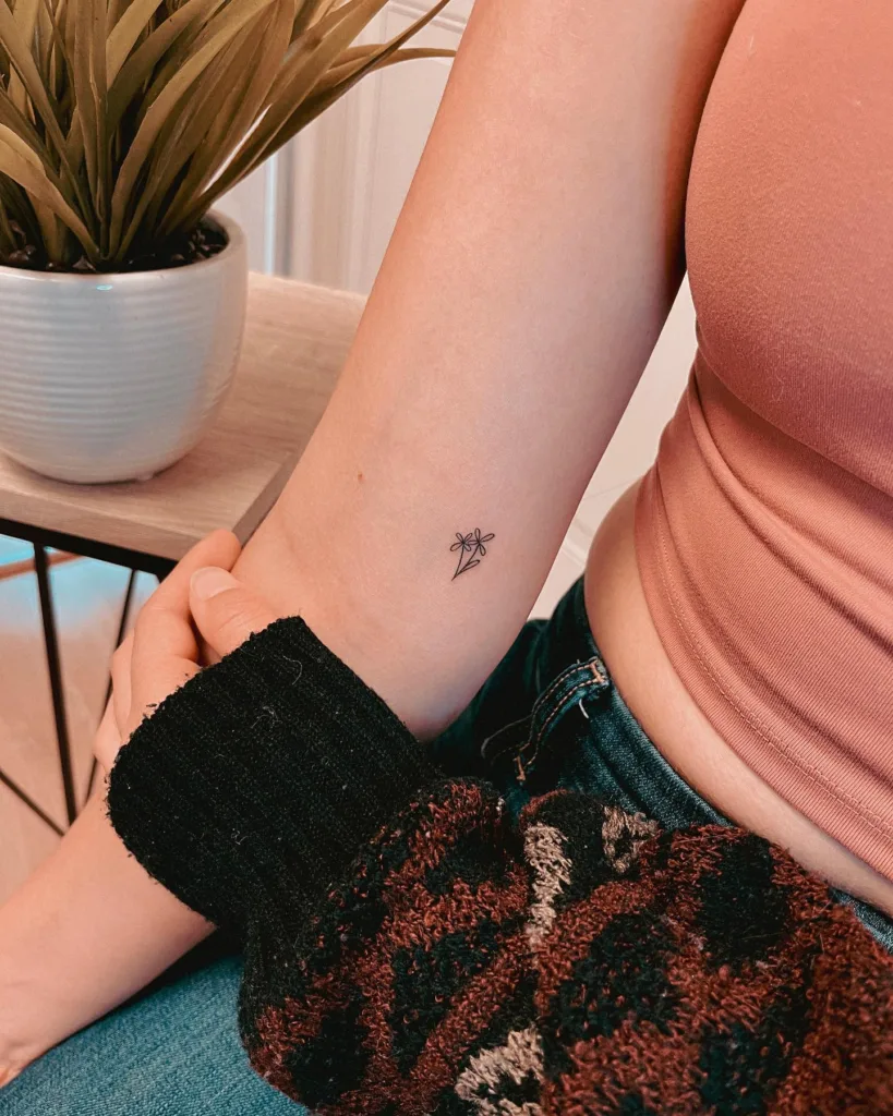 small fine line flower tattoo