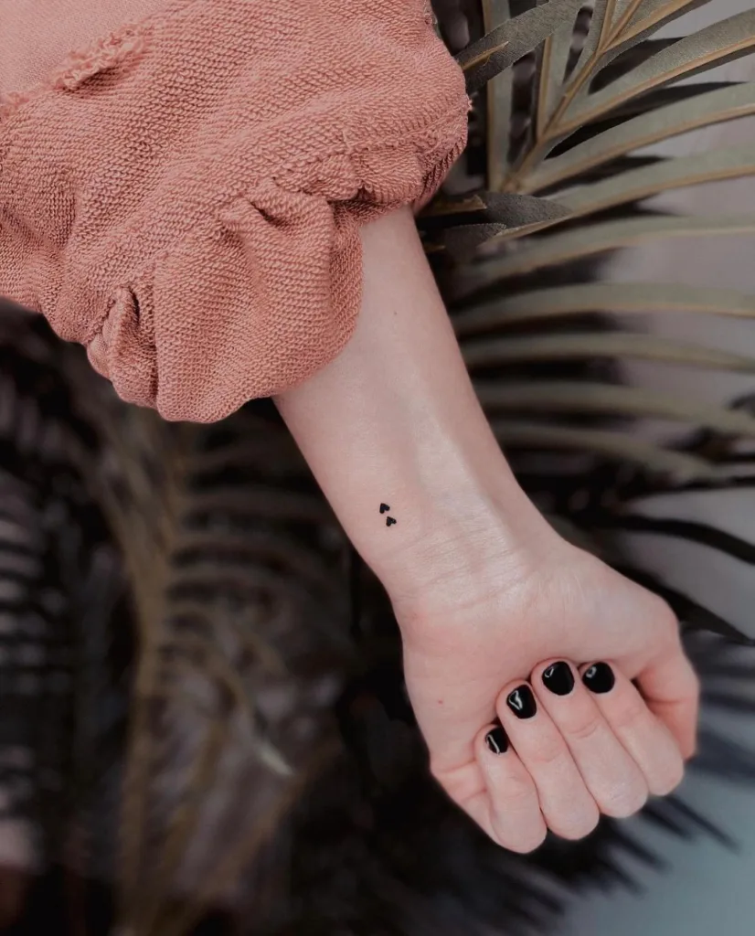 tiny double hearts wrist tattoo