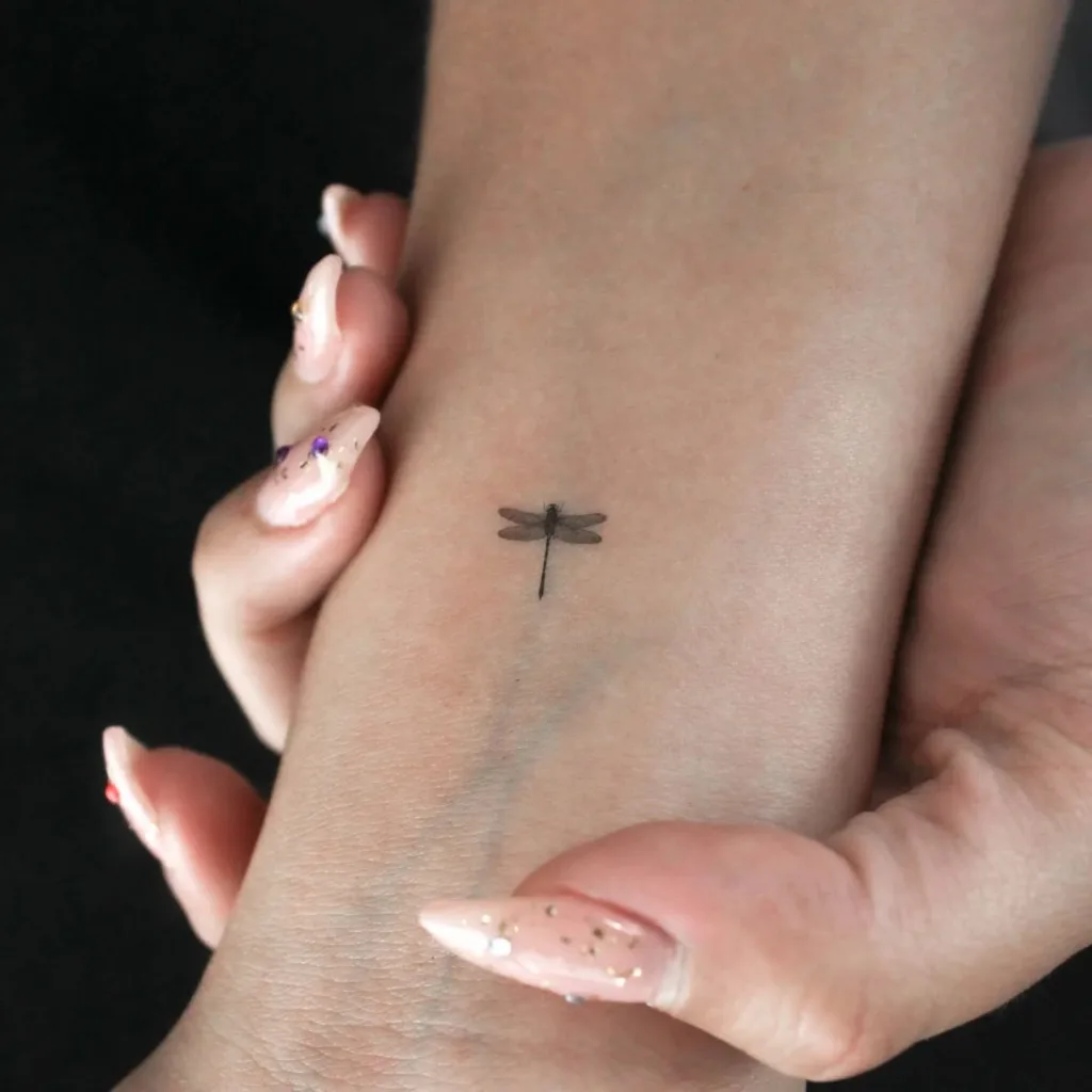 tiny dragonfly wrist tattoo