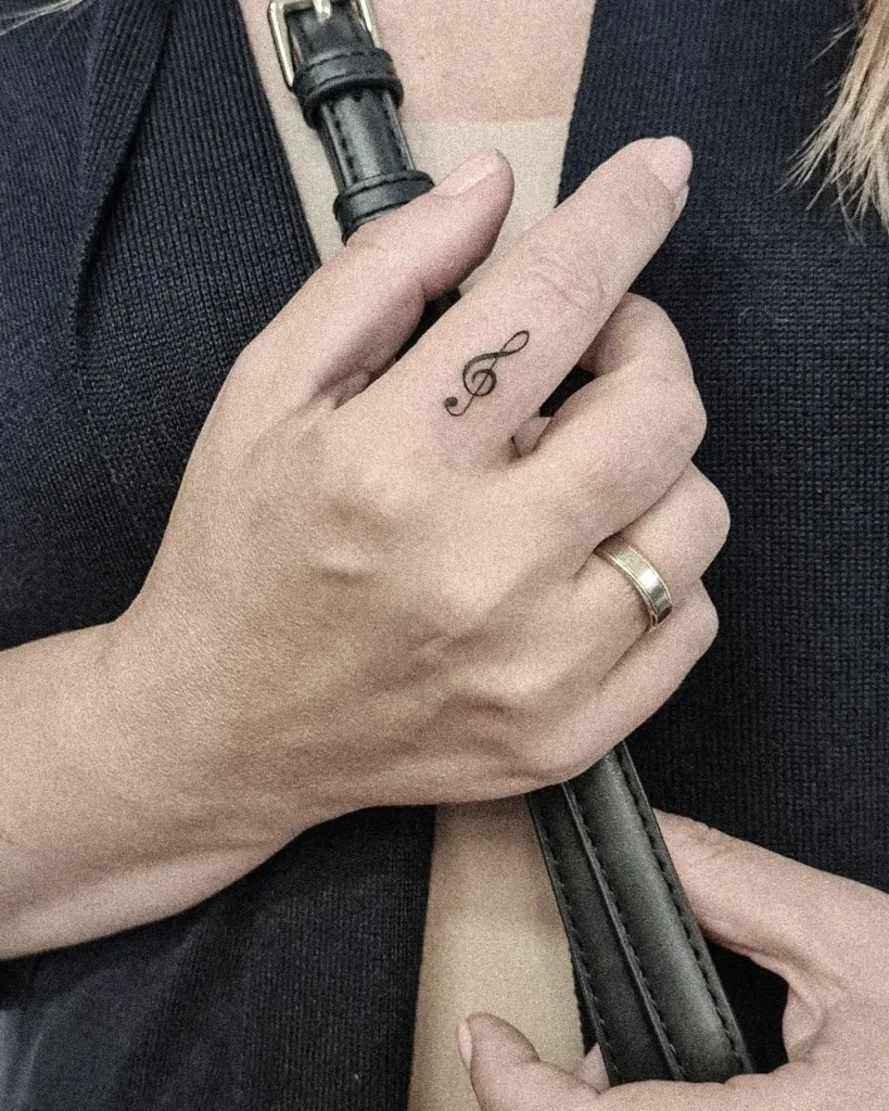 treble clef finger tattoo