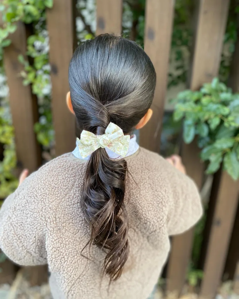 twisted low ponytail with curls