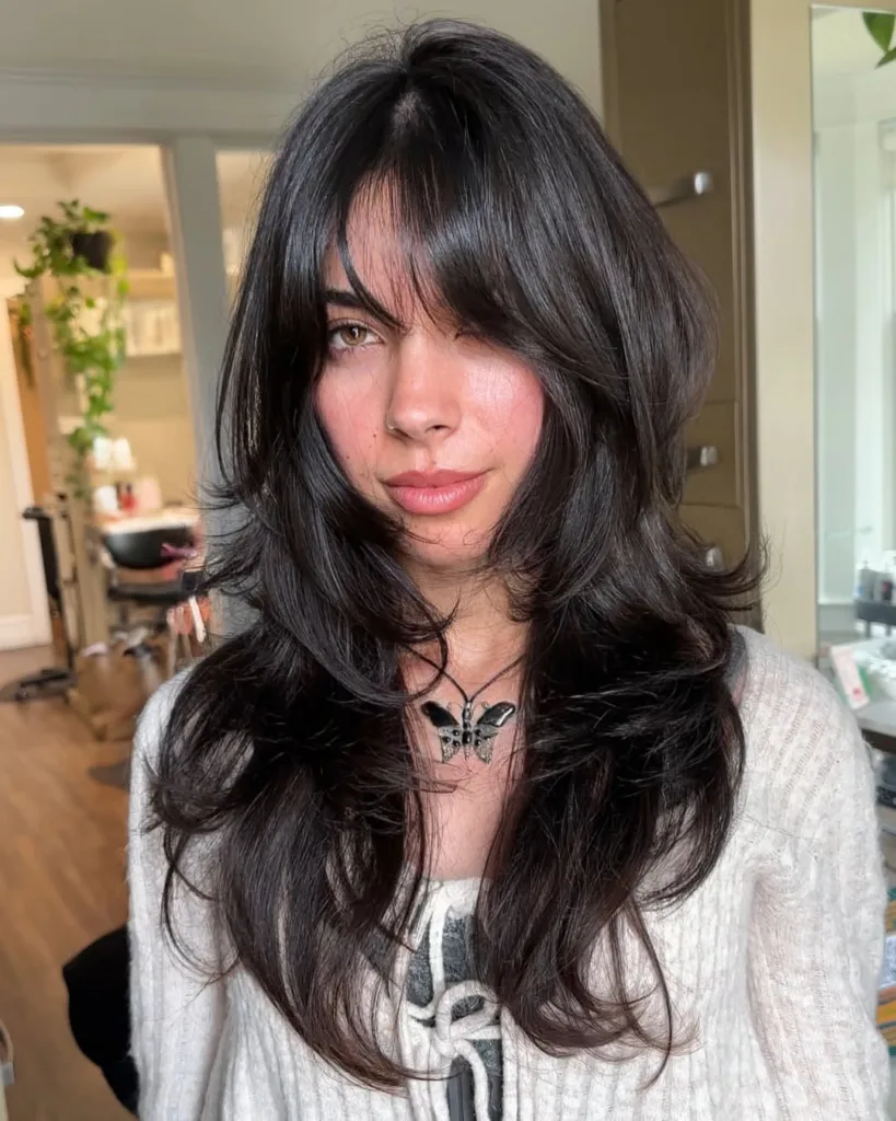 long layered wolf haircut with curtain bangs