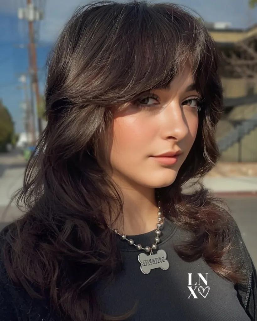 medium-length layered wolf cut with curtain bangs