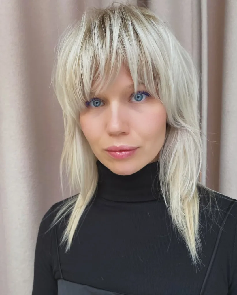 platinum blonde shaggy wolf cut with micro bangs