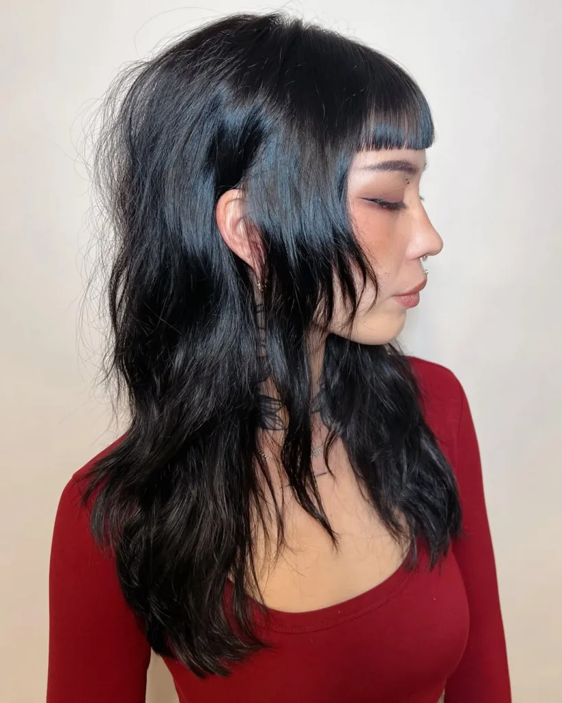 textured wolf haircut with blunt bangs