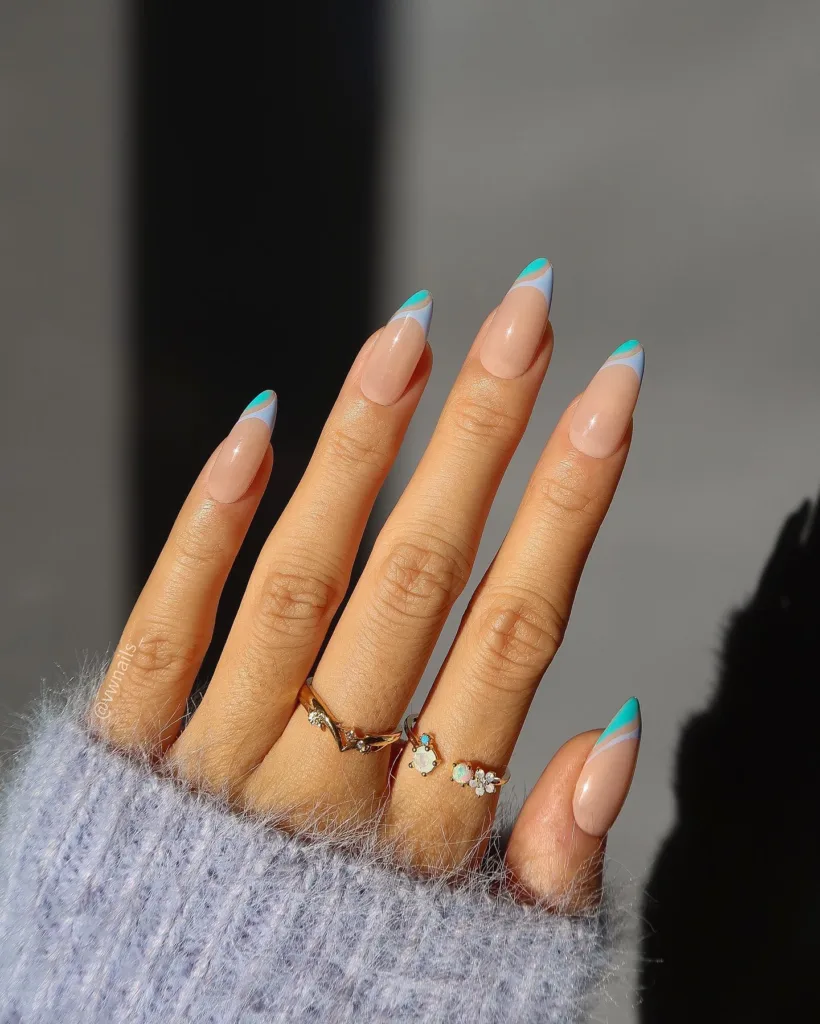 Almond nails with angled turquoise French tips
