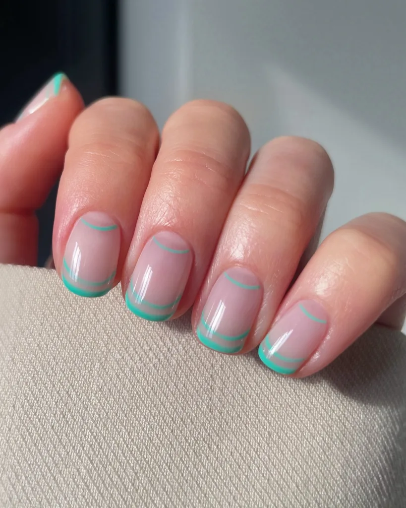Nude nails with thin double turquoise French tips