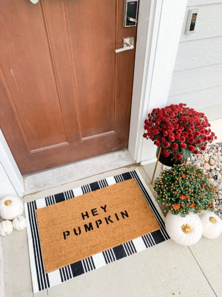 DIY Hey Pumpkin doormat with plaid rug and pumpkins for fall porch decor
