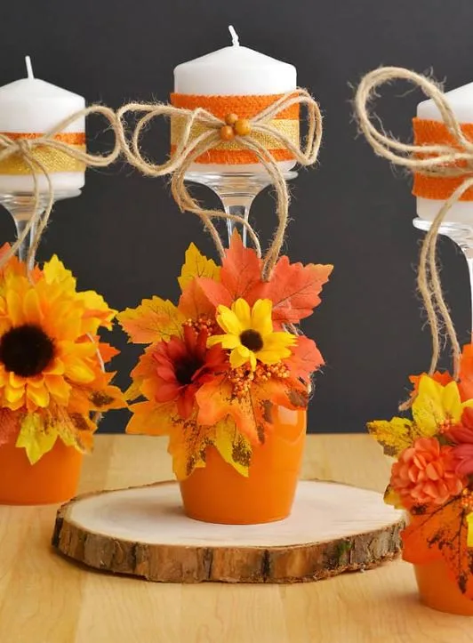 DIY fall candle holders with orange pots flowers and autumn leaves